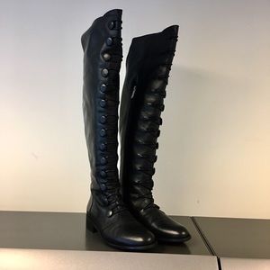 Black tall leather boots over knee with buttons